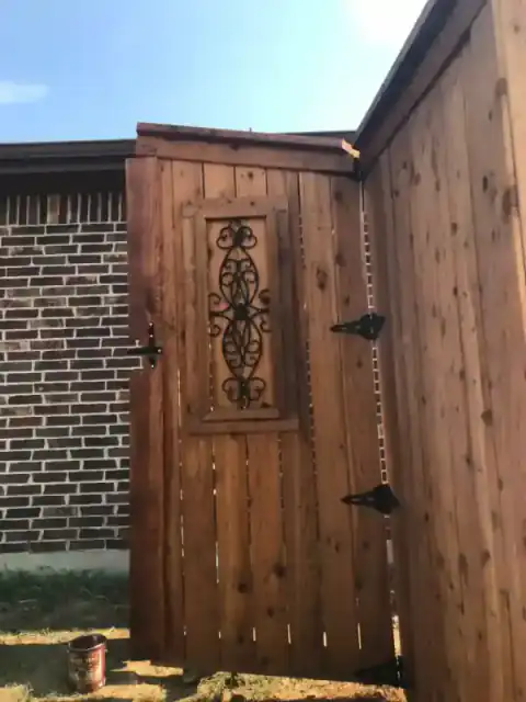 Cedar privacy fence runs along a home's narrow side yard.