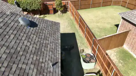 Aerial view of cedar fencing around homes and swimming pools.