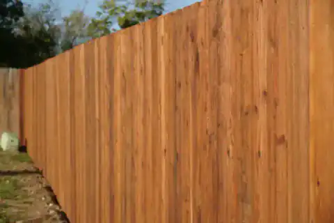 Cedar privacy fence close-up shows sturdy support posts.