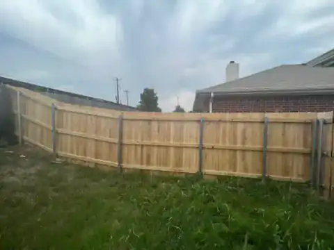Cedar privacy fence encloses a residential backyard.