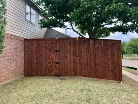 Cedar privacy fence lines a residential backyard.