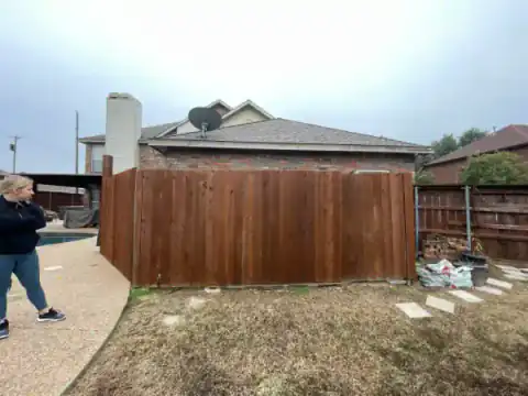 Cedar gate closes a residential side yard.